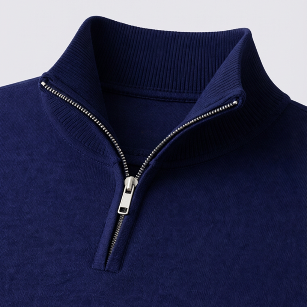 Navy blue sweater with a quarter zip on a light gray background